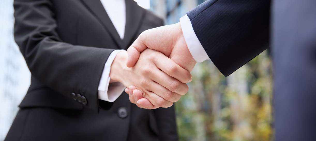 Business handshake representing successful company milestone and strategic partnership