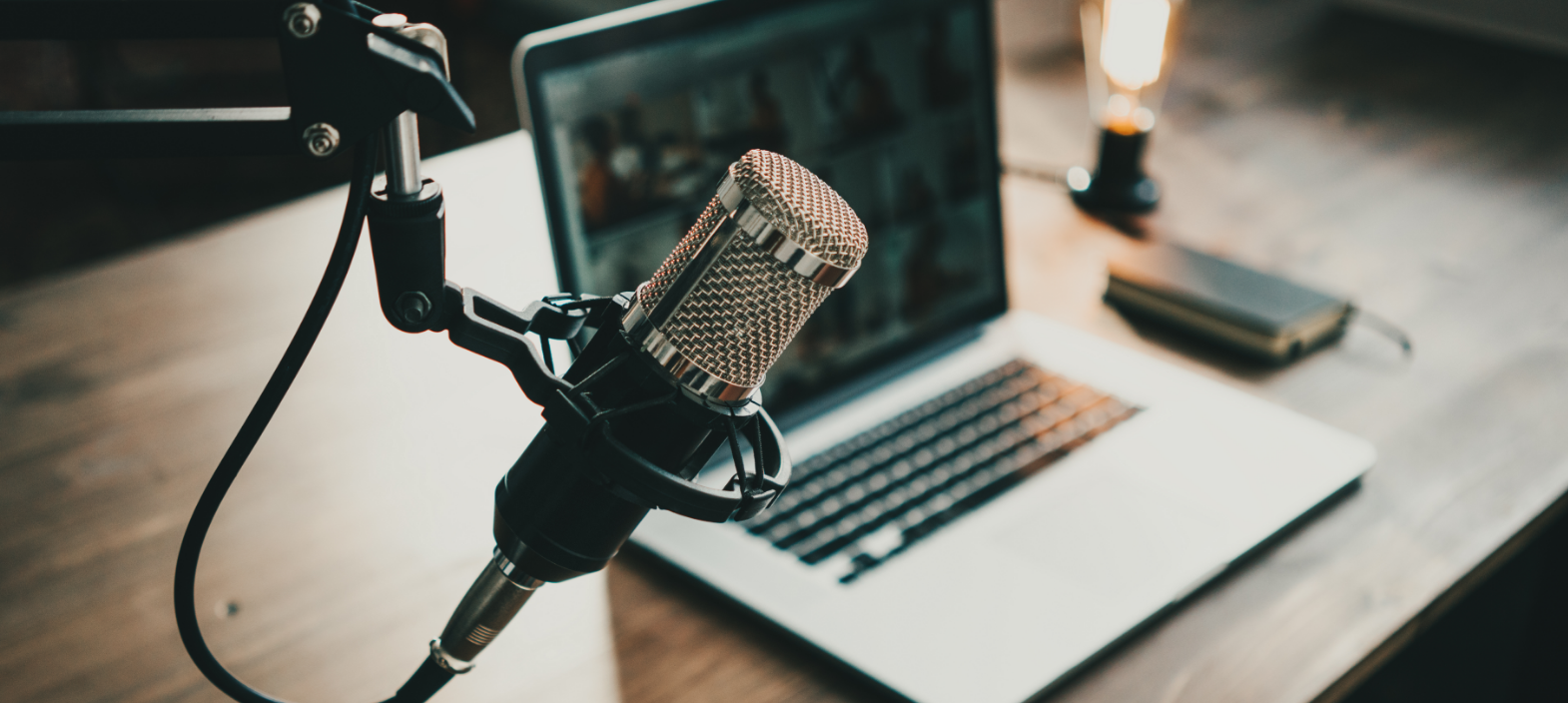 Professional podcast microphone and laptop representing digital media, thought leadership and evolving public relations strategies.